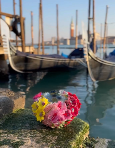 Floral composition made of silicone set among the gondolas in Venice